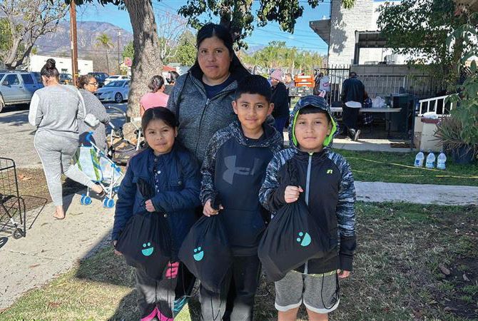 A family receives food support after the California fires