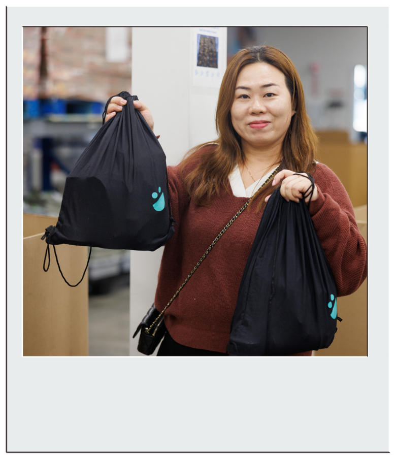 A volunteer holds up a packed weekend bag