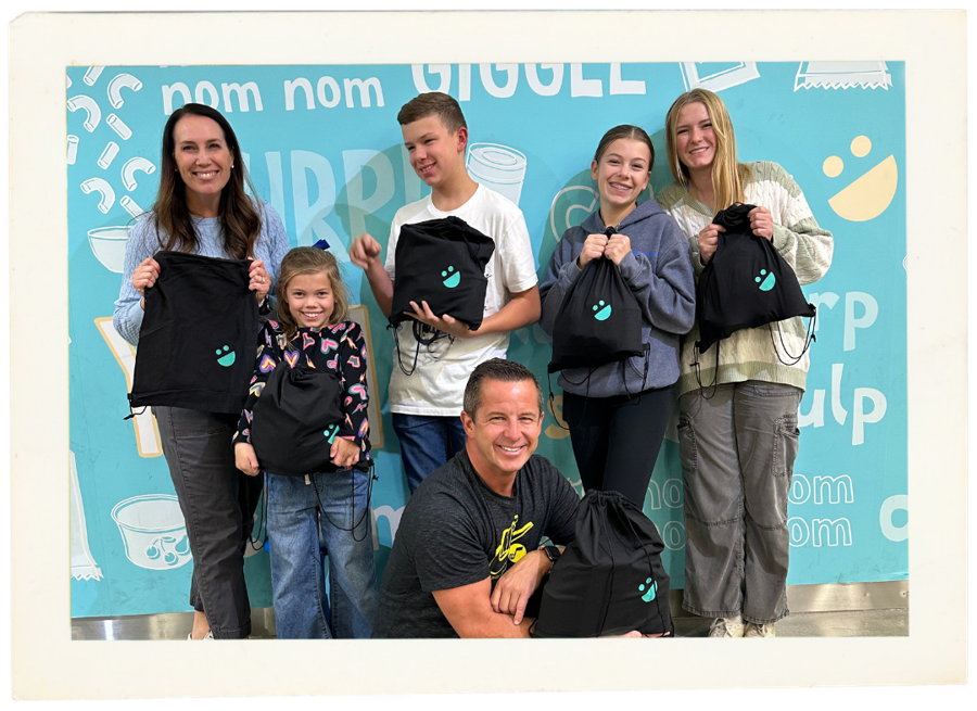 A sponsor family volunteering at the USANA Kids Eat warehouse