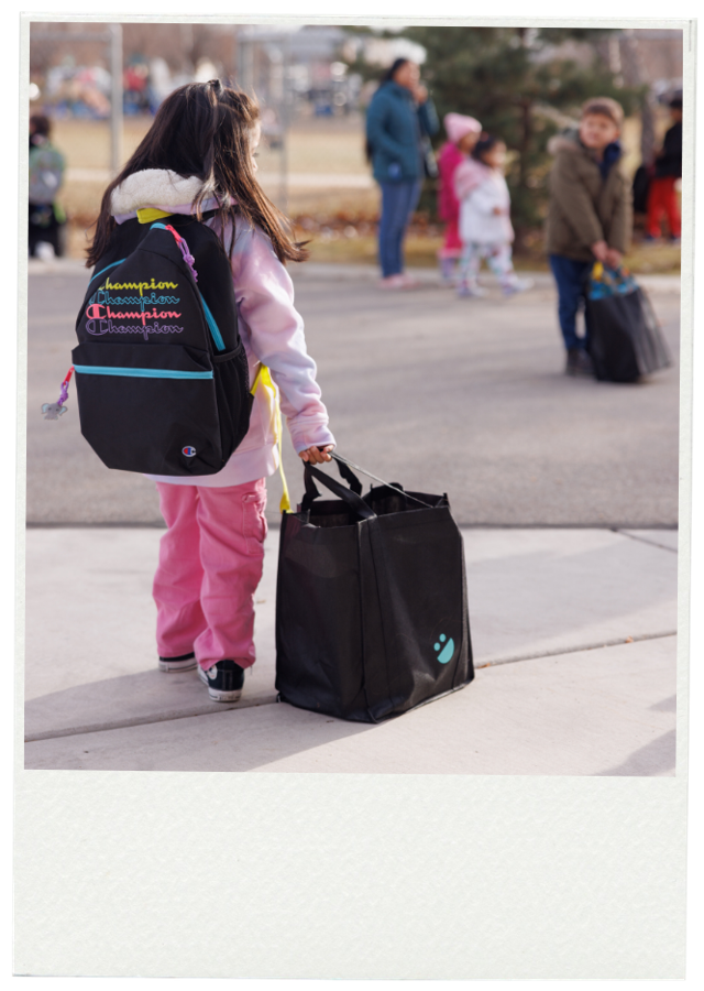 A student heads home with a USANA Kids Eat bag