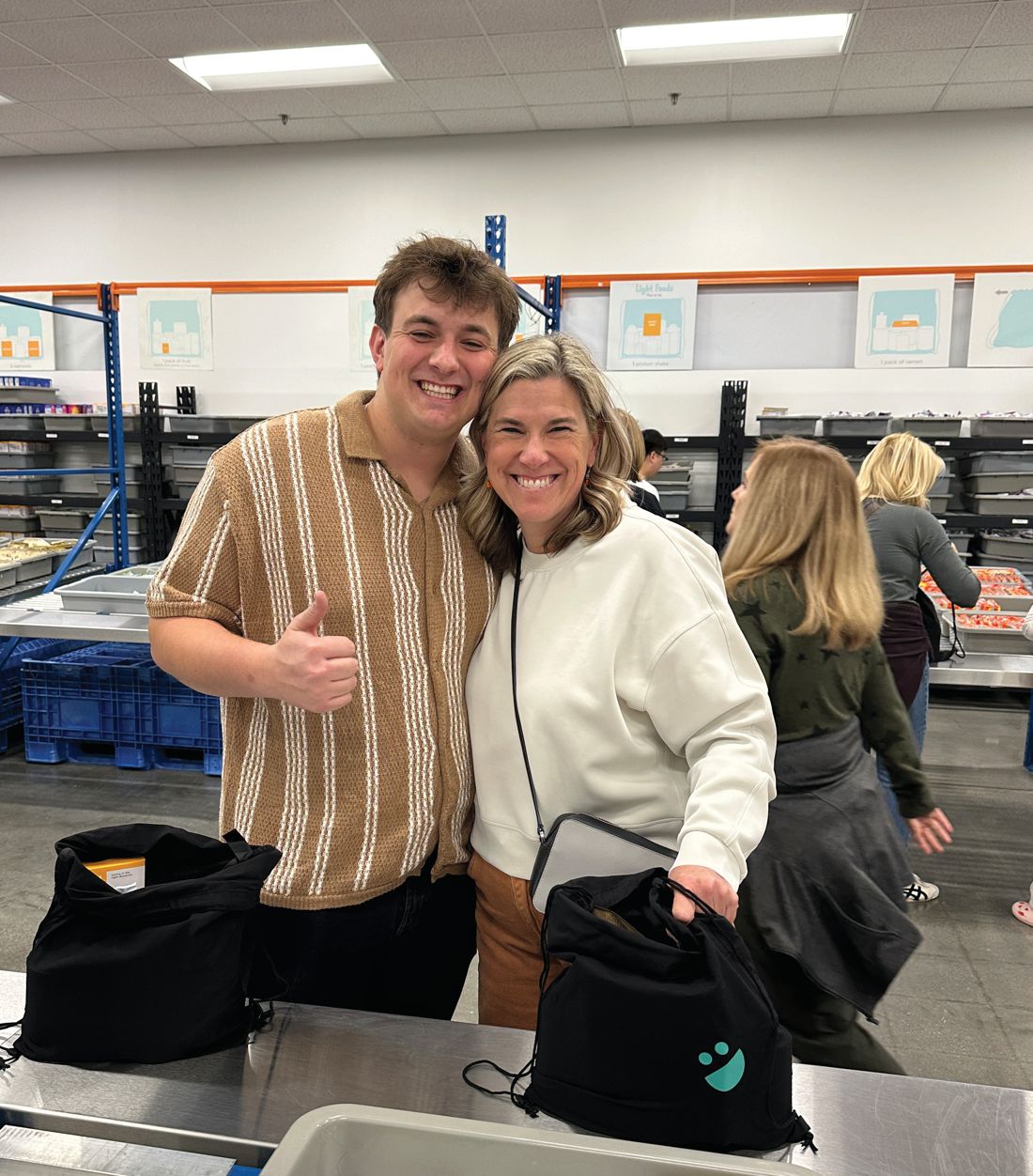 Volunteers smile with finished bags