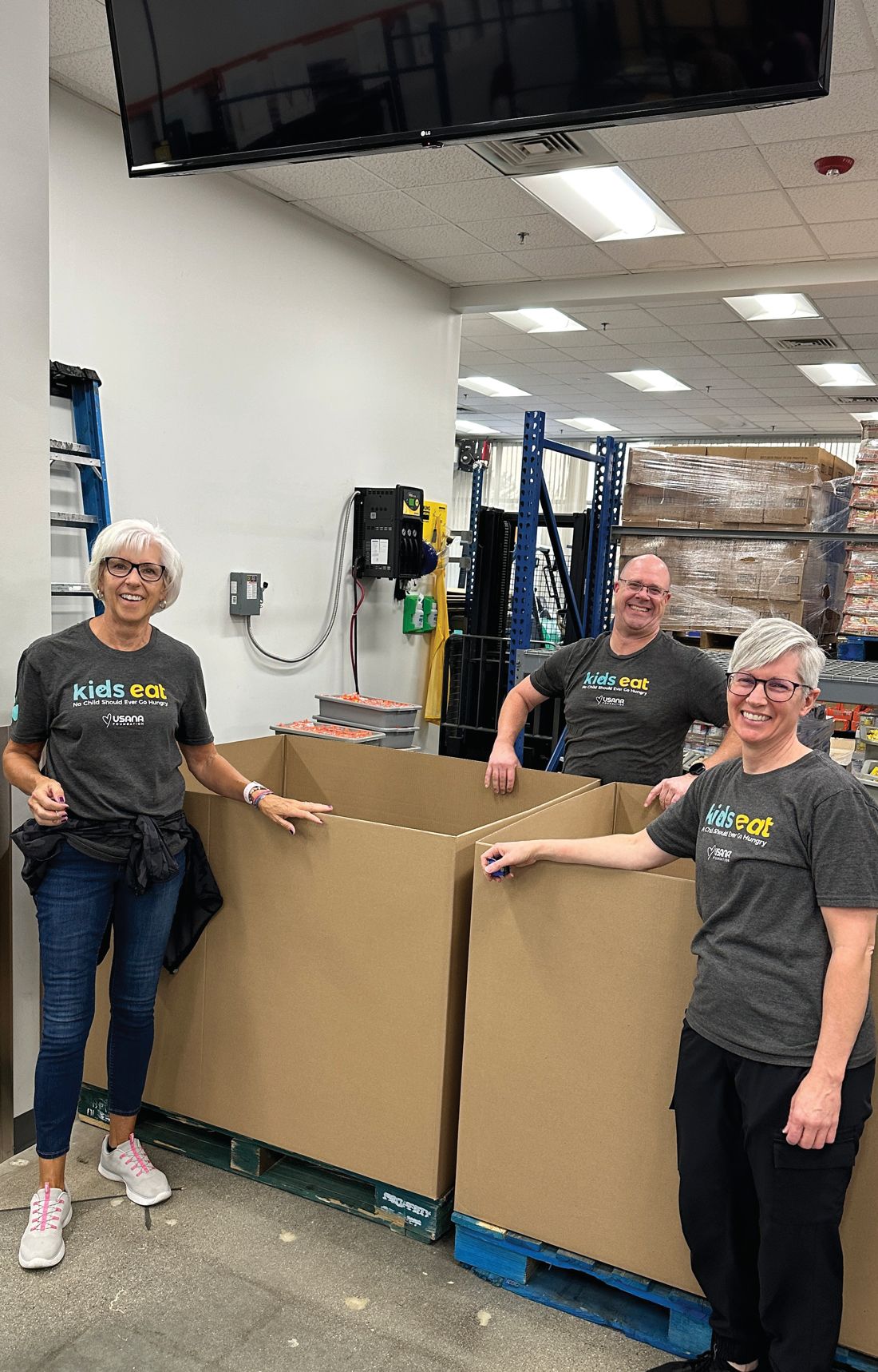 Volunteers fill boxes of bags
